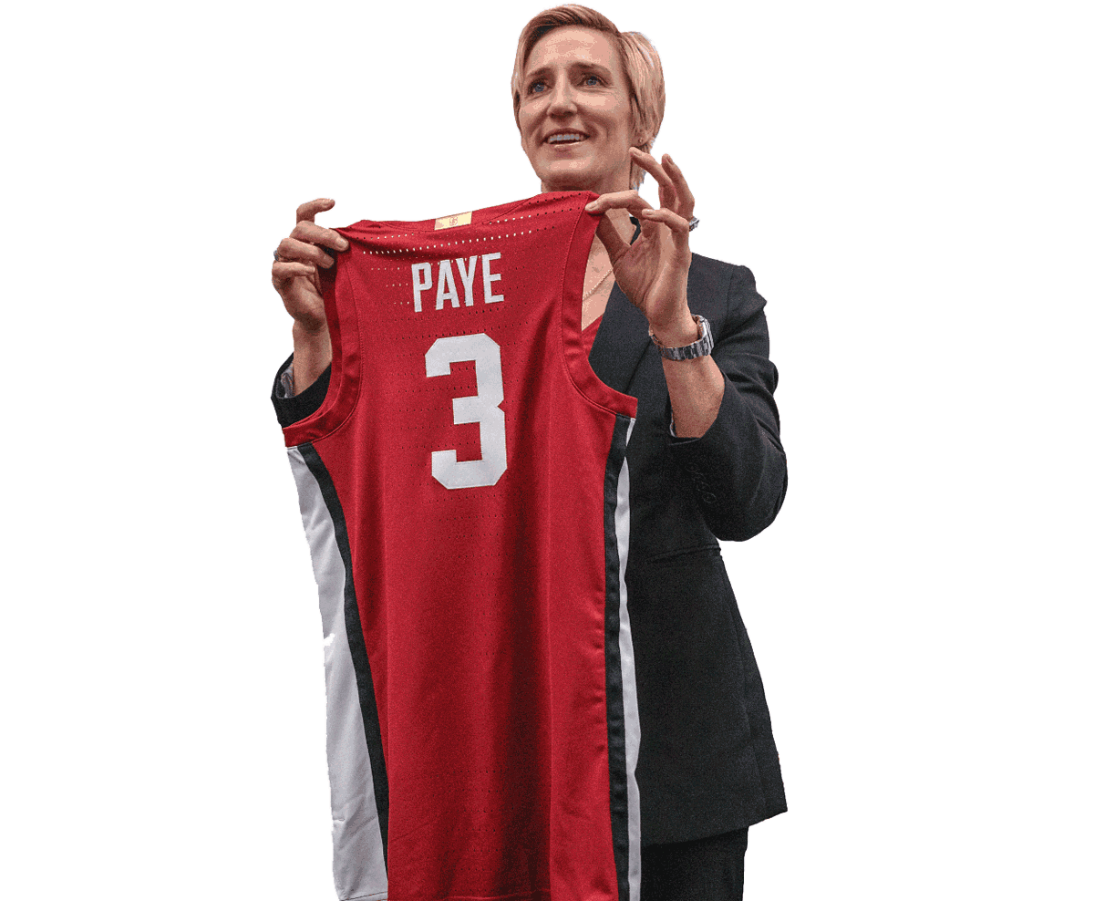 Paye holds up a jersey displaying the number 3 and her name.