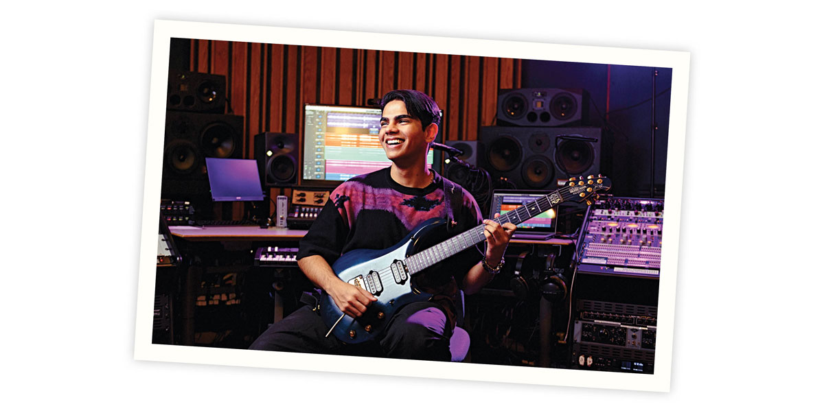Tamish Pulappadi playing guitar in a recording studio.
