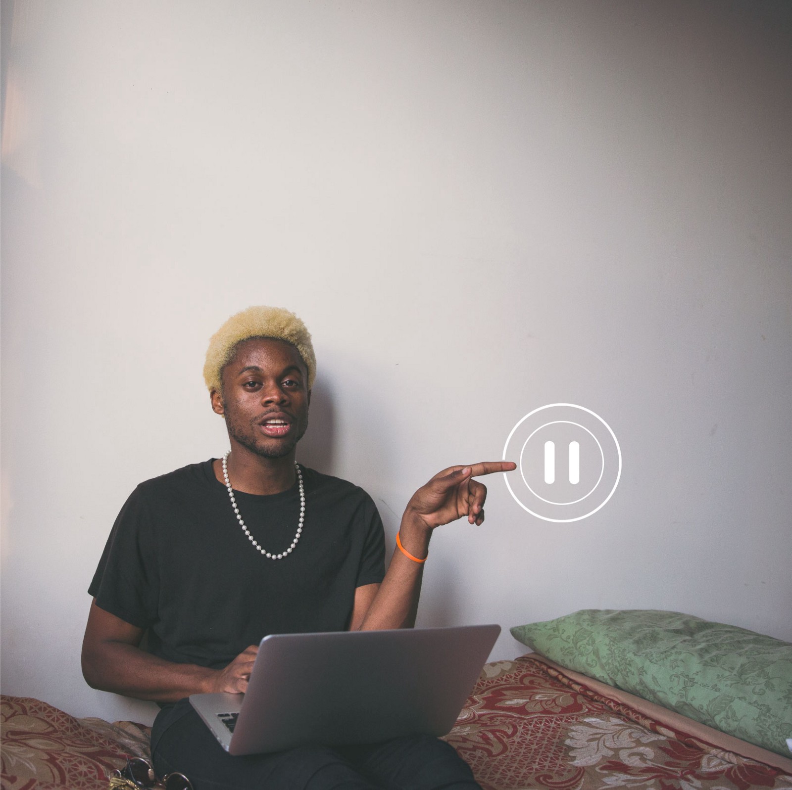 Man sitting on his bed on a laptop