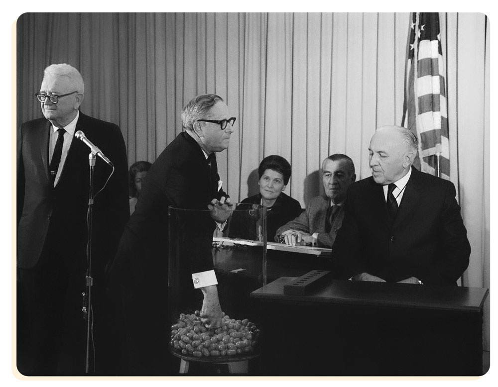 Historical photo of Rep. Alexander Pirnie drawing the first birthdate in the December 1, 1969 draft lottery.