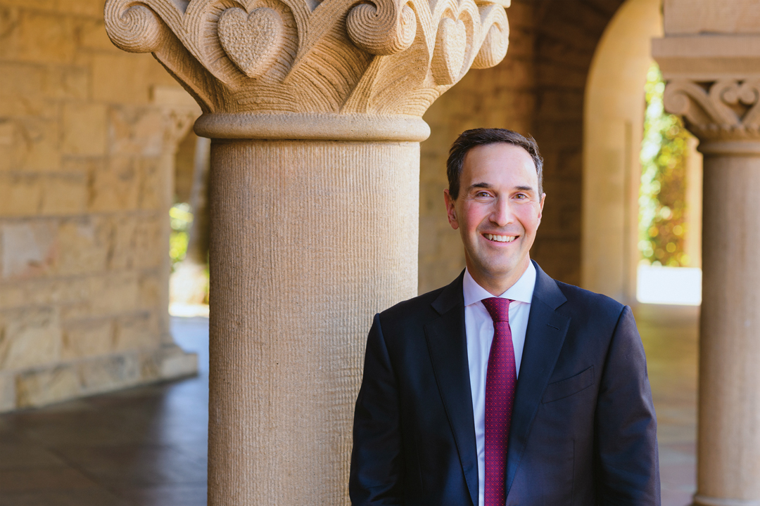 Portrait of Jonathan Levin in the Quad standing by a column
