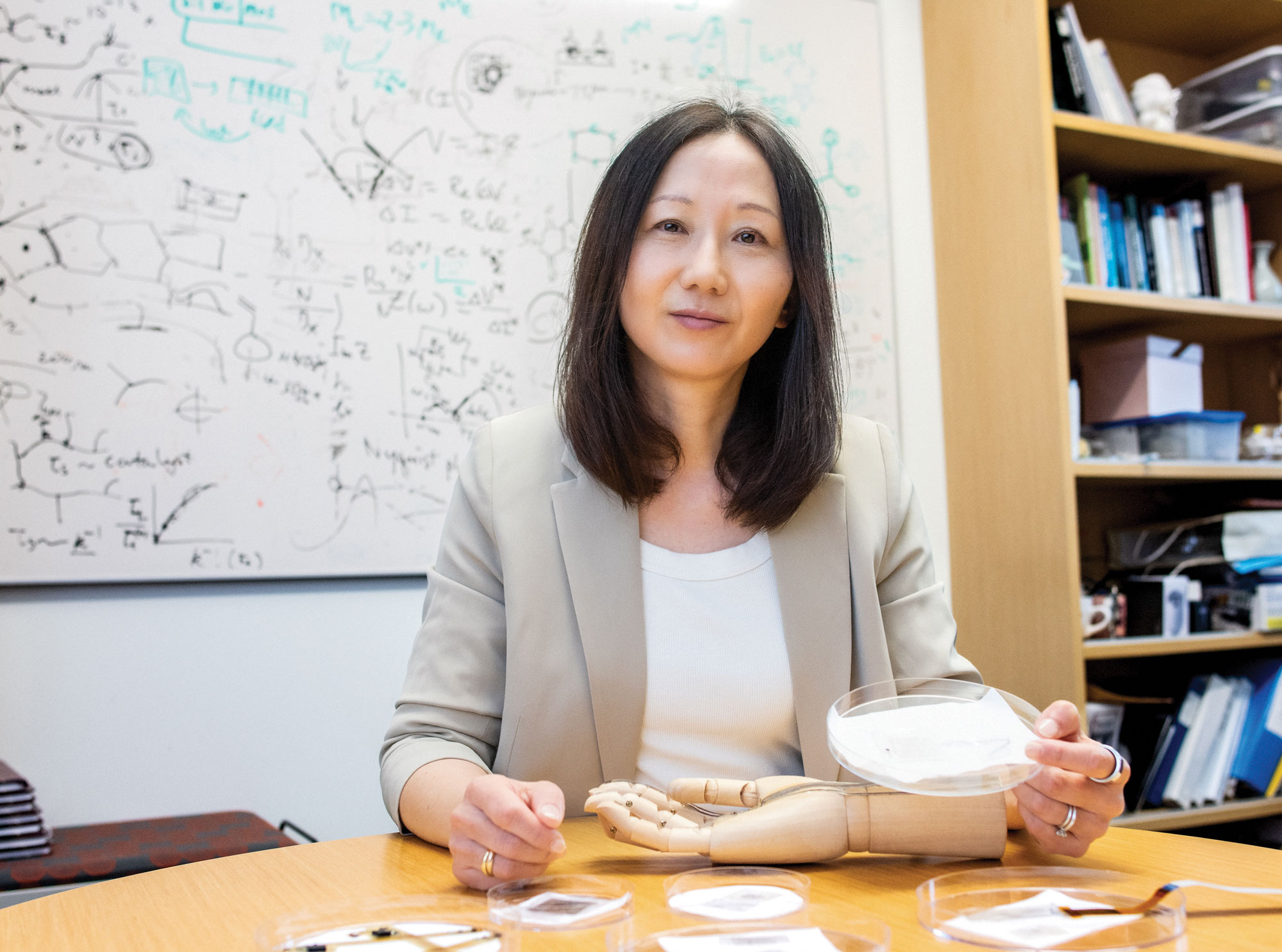 Photo of Zhenan Bao at a table.