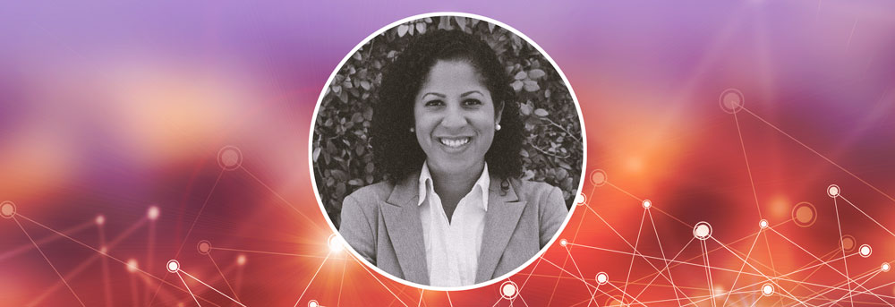 Headshot of Megan McKoy against leafy bush