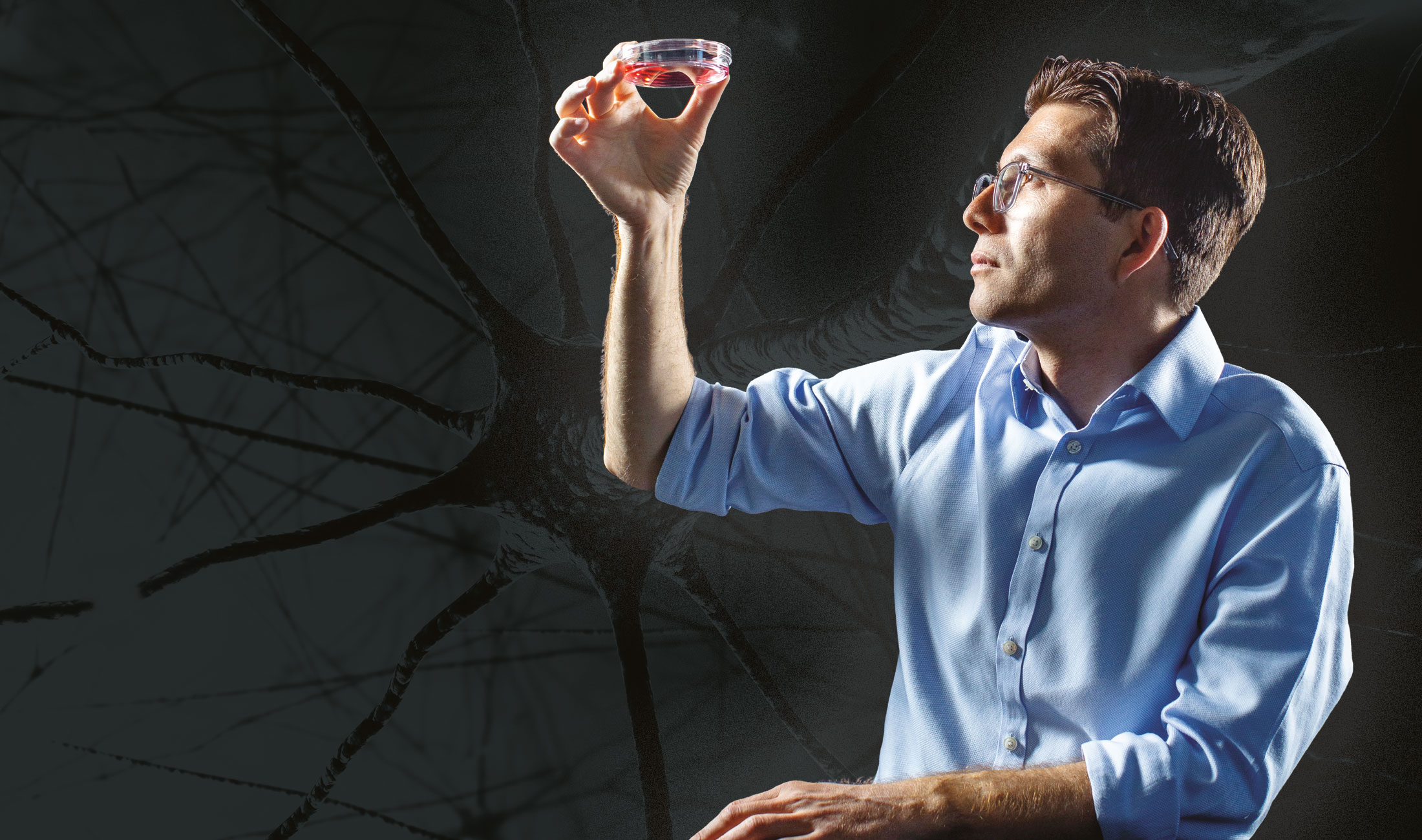 Pașca holding a petri dish against a background of neurons