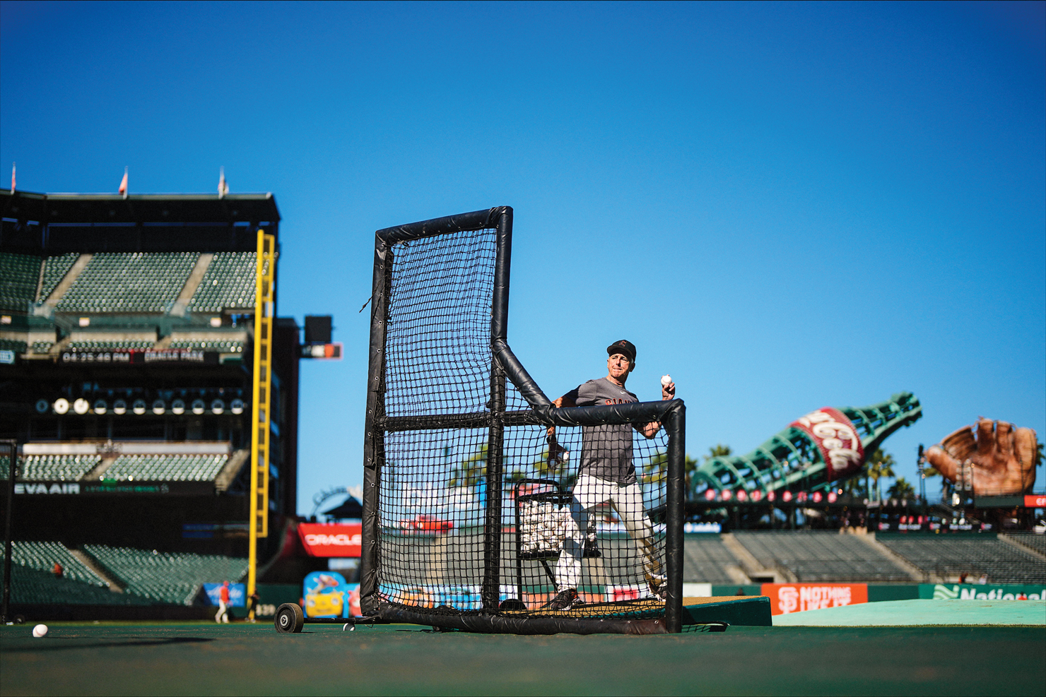 John Yandle pitching from behind the screen at Oracle Park
