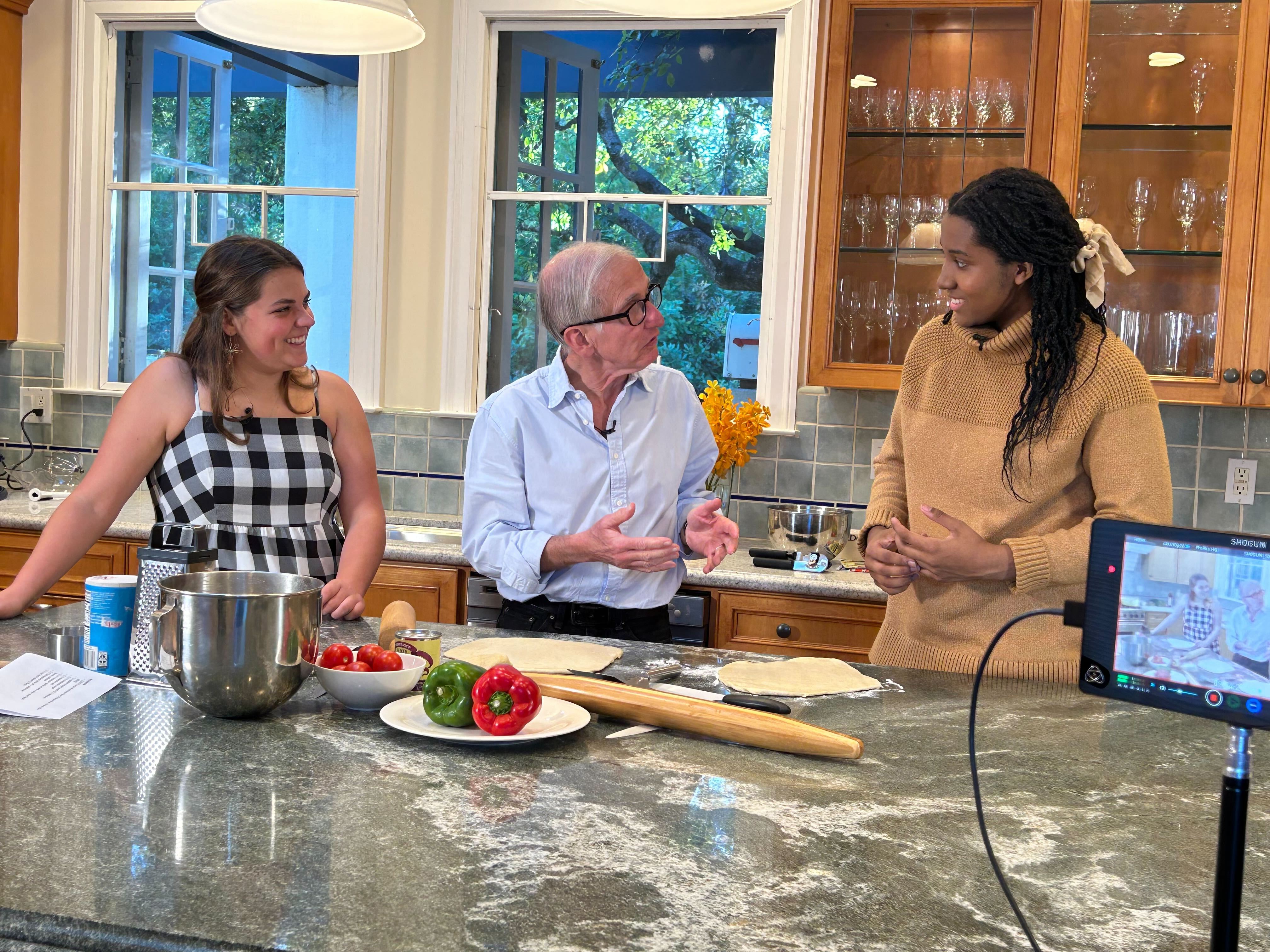 Saller, at a kitchen counter, flanked by interns Annie Reller and Kalissa Green