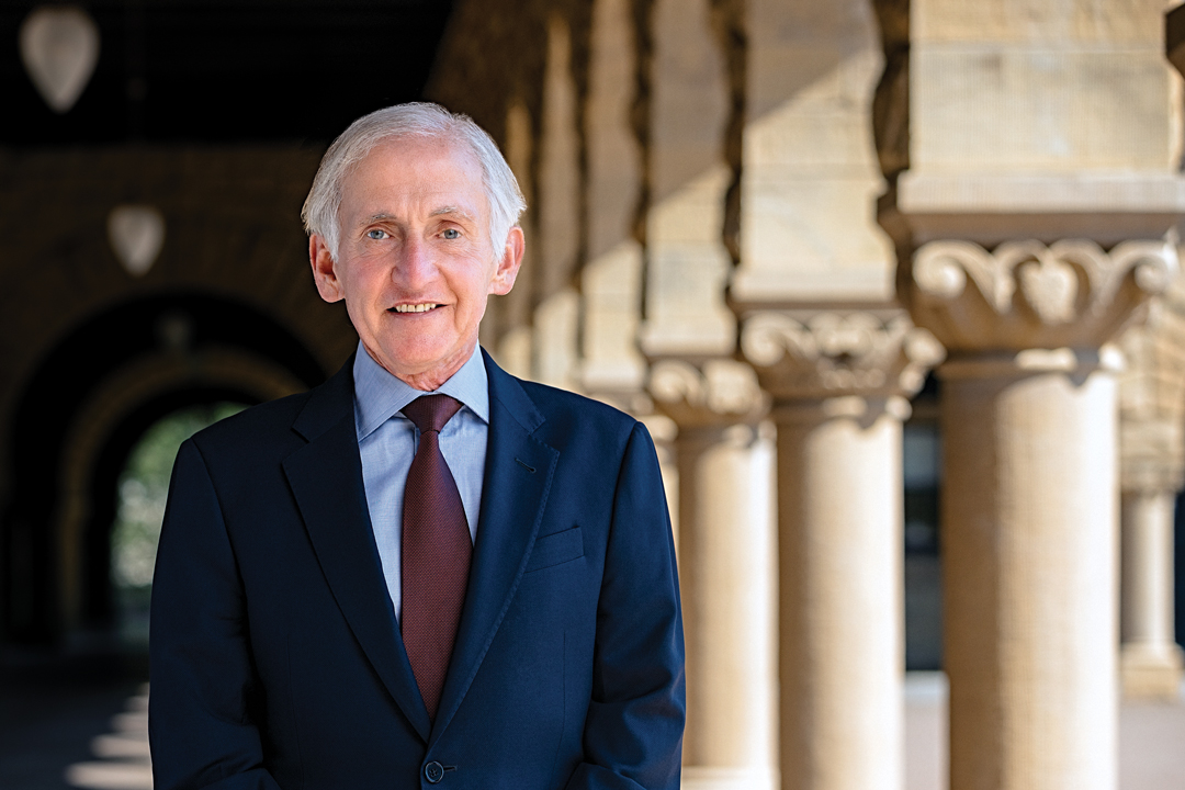 Richard Saller portrait standing by columns