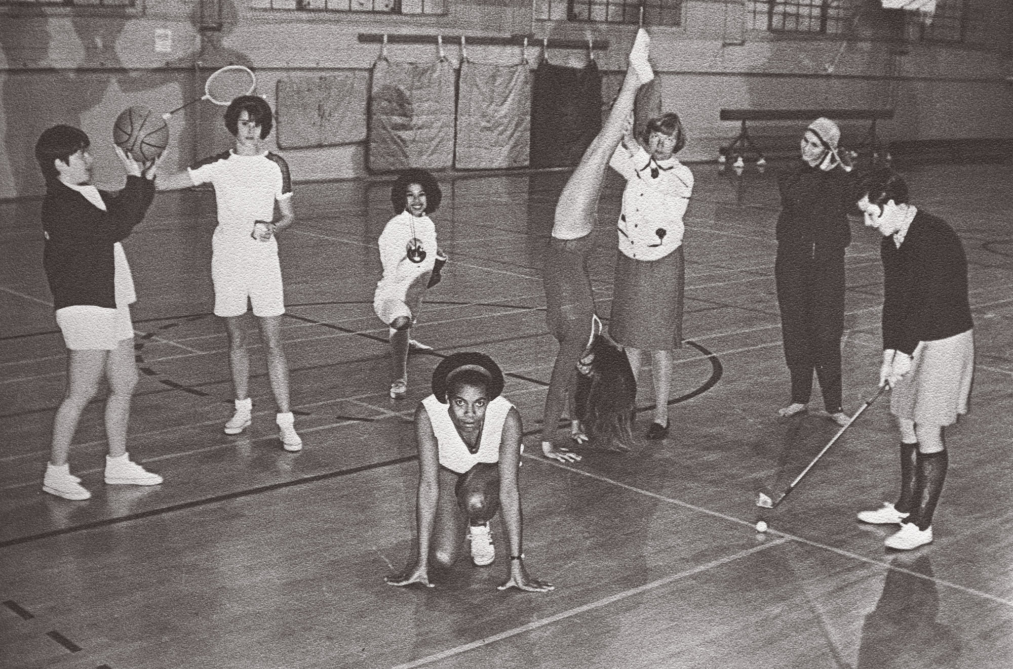 Women athletes with different sporting equipment inside a gymnasium