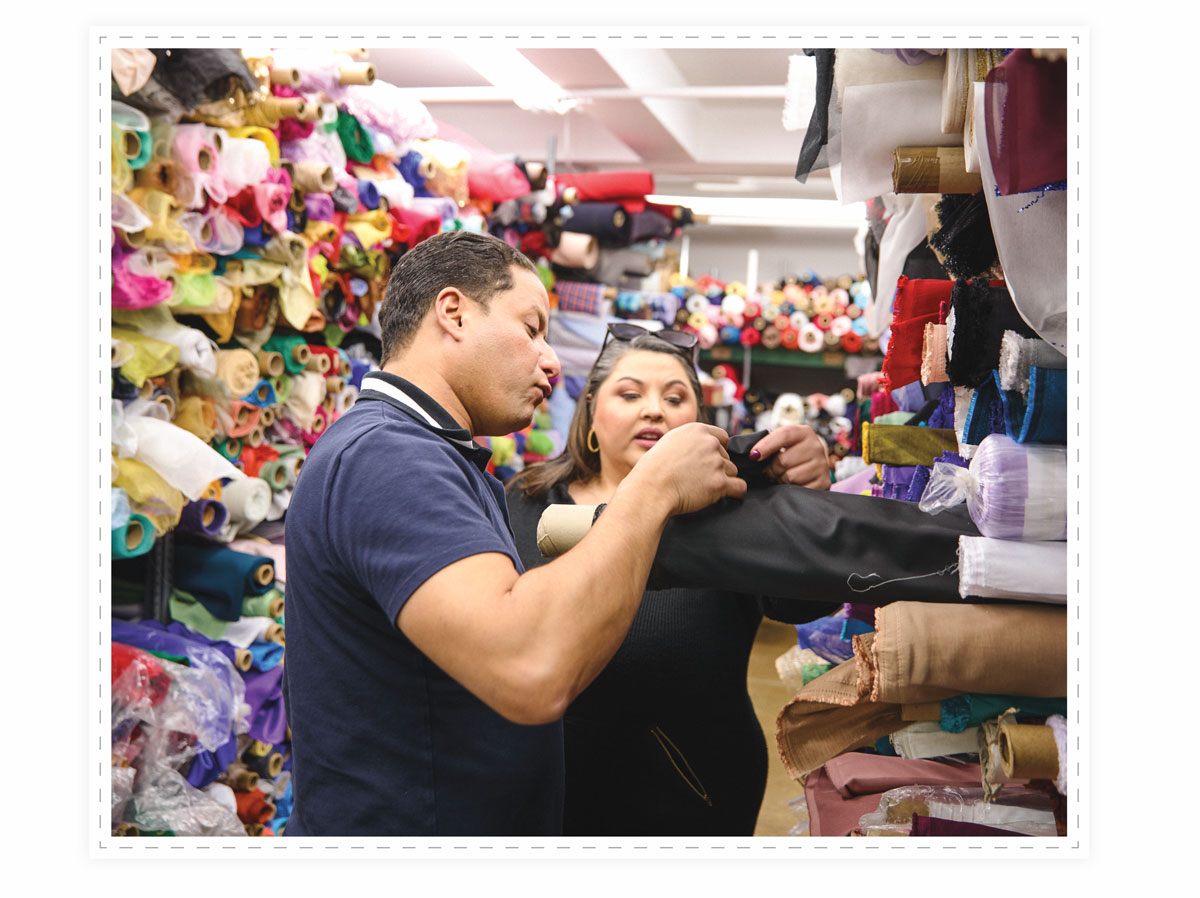 Cafaro looking at fabric at a fabric store.