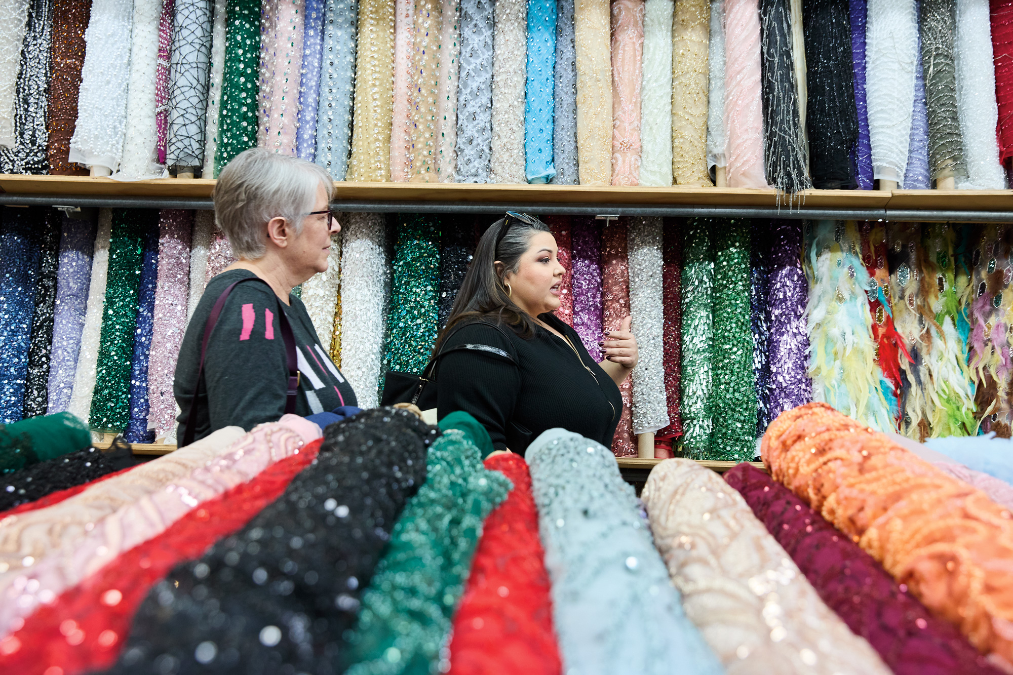 Kathy Zonana and Renee Cafaro in a space with many bolts of fabric