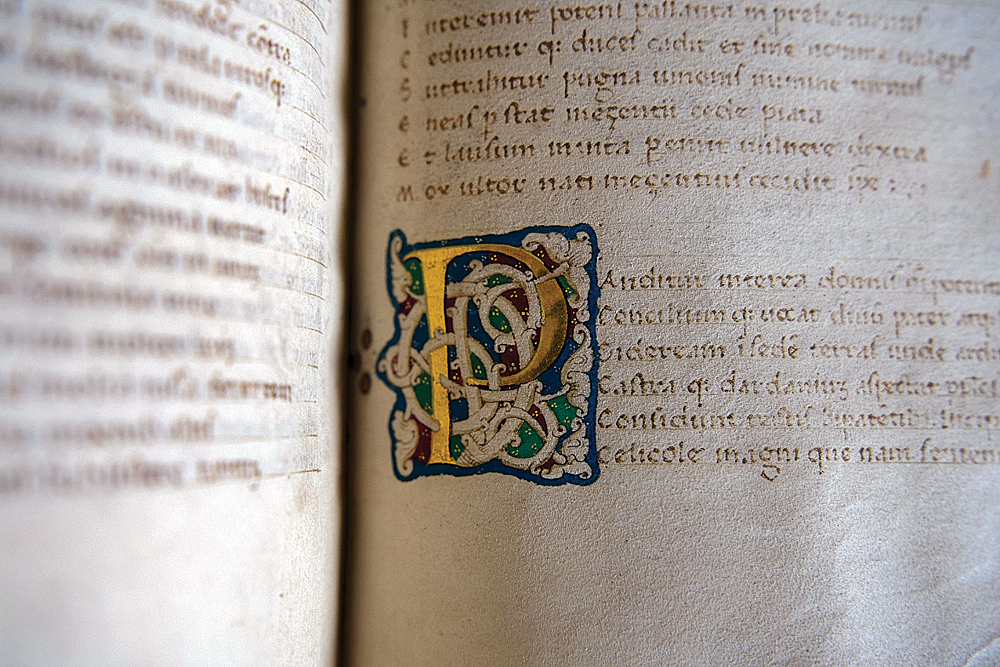 Close-up view of a page from the rare book, including an ornate letter P.