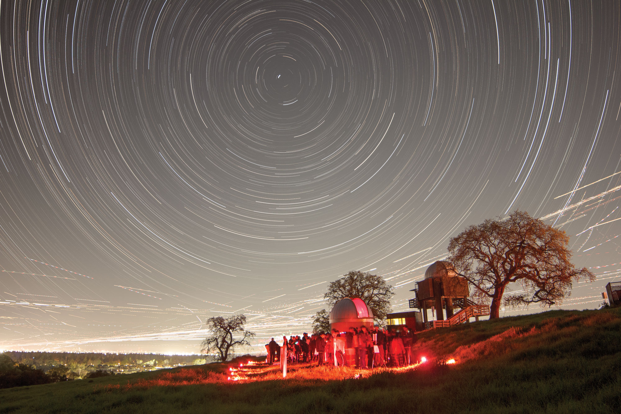 Stanford Student Observatory at night with stars swirling in a giant circle