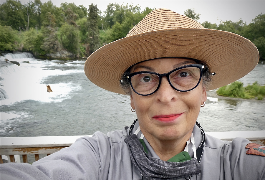 Selfie of Naomi Boak with a bear in water behind her
